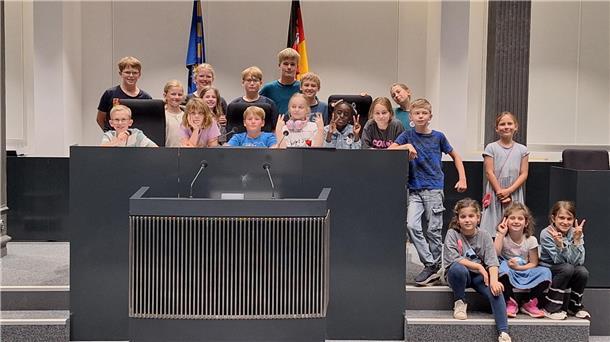 Gruppe Kinder hinter Rednerpult 