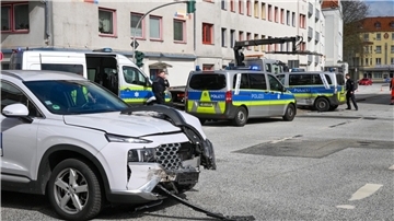 Zwei beschädigte Autos stehen auf einer Kreuzung.