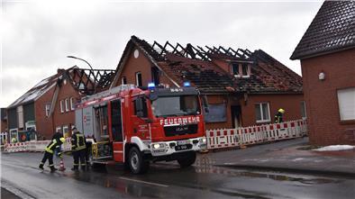 Ein Feuerwehrfahrzeug steht in dem Ort Beverstedt vor den Häusern.  Je zwei Wohn- und Geschäftsgebäude gerieten am Wochenende in Brand.