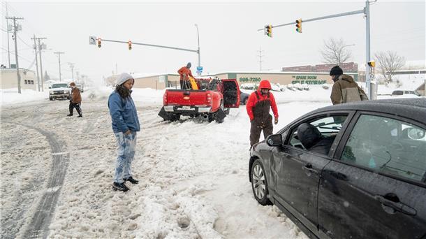 Mehrere Tote bei Schneesturm im Nordosten der USA Anwohner helfen einem im Schnee steckengebliebenen Autofahrer in Buffalo.