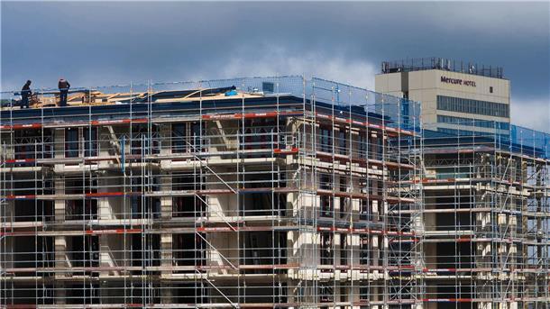 Forderung nach mehr Geld für klimagerechten Neubau Arbeiter stehen auf dem Dach eines Rohbaus. Der Bundesverband deutscher Wohnungs- und Immobilienunternehmen benötigt mehr Geld für den klimagerechten Neubau.