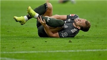 Bayern-Stürmer Harry Kane hält sich nach einem Zweikampf den Knöchel.