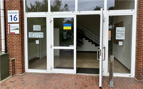 Der Eingang des Welcome Points in Dorum - Glastüren auf denen die Ukrainische Fahne klebt. 