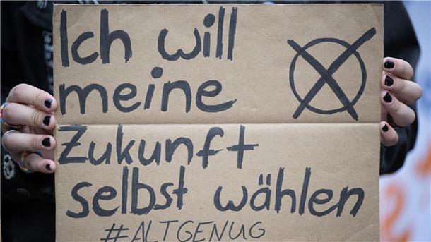 Eine Frau hält ein Plakat mit der Aufschrift "Ich will meine Zukunft selbst wählen".