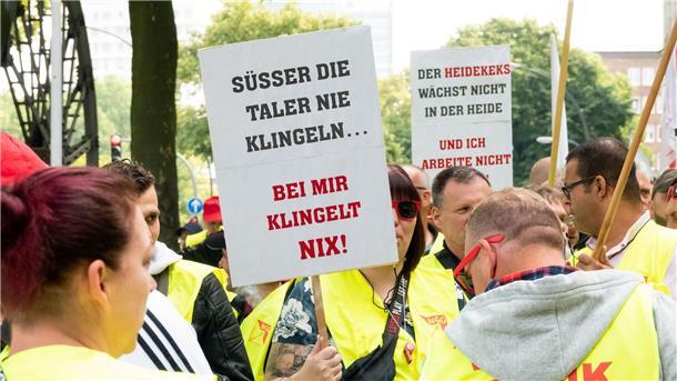Beschäftigte der Süßwarenindustrie demonstrieren in Hamburg Beschäftigte der Süßwarenindustrie stehen während einer Kundgebung zusammen.