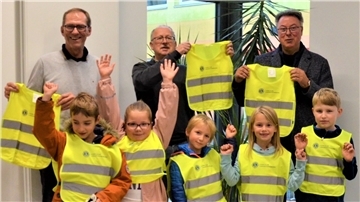 Der Lions Club Langen-Pipinsburg hat Schülern Warnwesten übergeben: Schatzmeister Thomas  Koch (von links), Klassenbetreuer Dr. Thomas Kossow und Präsident Norbert Behrends.