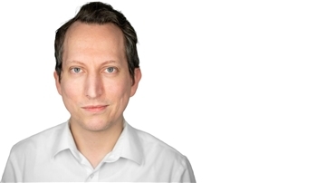 Auf dem Foto ist ein Mann in einem weißen Hemd zu sehen. 