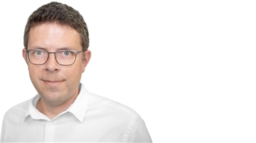 Mann mit Brille und weißem Hemd.