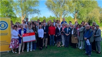 Gruppenfoto mit vielen Menschen und einem Spendecheck in Höhe von 20.000 Euro. Der Inner Wheel Club Bremerhaven hat durch eine Spendengala 20.000 Euro gesammelt.