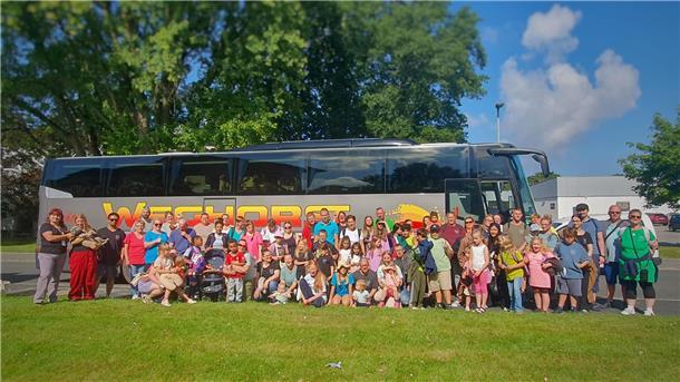 Eine Gruppe steht vor einem Reisebus