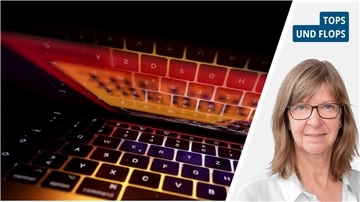 Die Tastatur eines Computers und das Porträt einer blonden Frau mit Brille.