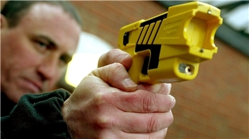 Polizist zielt mit Taser
