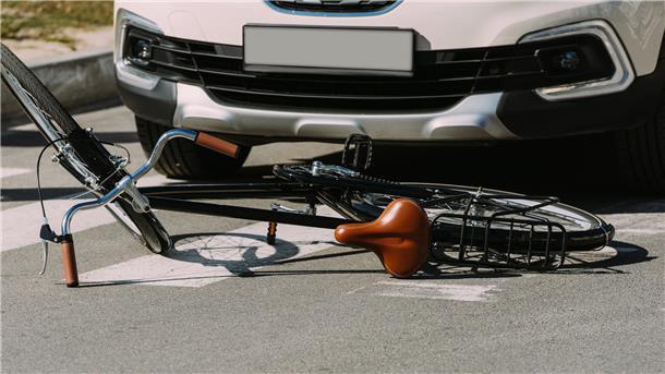 close up view of broken bicycle and car on road, car accident concept
