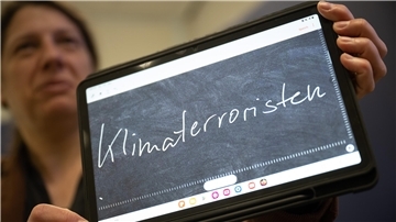 Constanze Spieß, Professorin am Institut für Germanistische Sprachwissenschaft der Philipps-Universität Marburg, hält ein Tablet in der Hand, auf dem das „Unwort des Jahres“ geschrieben steht.