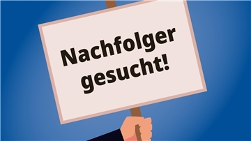 Eine Hand hält ein Schild, worauf steht, Nachfolger gesucht.