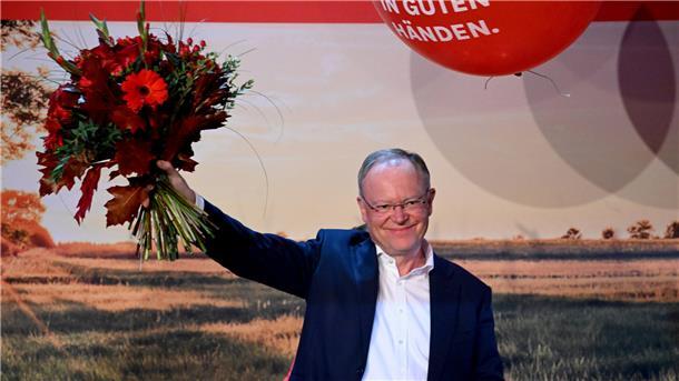 Ministerpräsident Weil mit Blumen.
