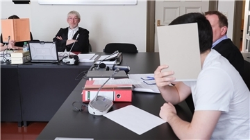 Junge IS-Anhänger aus Bremerhaven und Iserlohn wurden verurteilt. Sie verbergen in der Hauptverhandlung im Gerichtssaal ihre Gesichter hinter Aktenordnern.