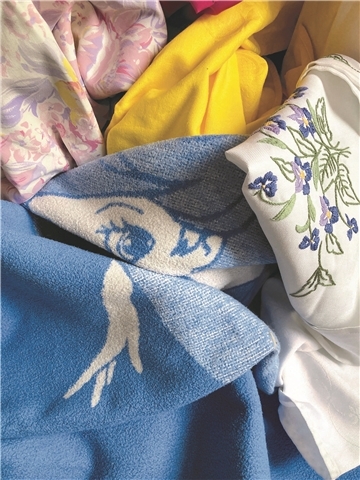 Ein buntes Kunstwerk. Die Ausstellung "Innere Oberfläche" von Jenny Schäfer lädt Besucher dazu ein, in die Tiefen von Erinnerungen und innerer Heimat einzutauchen. Ihre Installation aus Fotografien und Alltagsgegenständen schafft einen Raum der Reflexion.