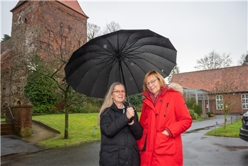Annegret Warnecke und Silla Funck vom Kirchenvorstand der Gemeinde Wulsdorf in Bremerhaven vor der historischen Dionysiuskirche