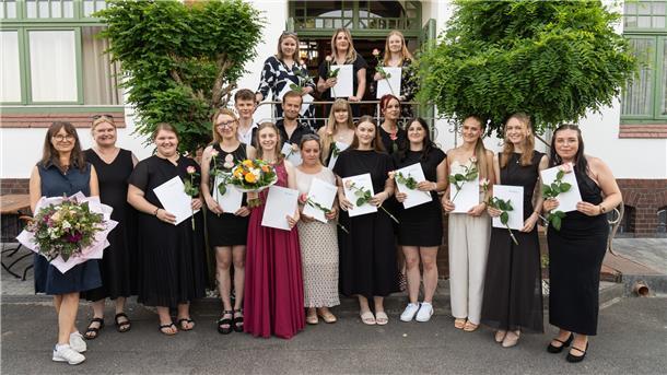 Die Fachklasse Zeven mit Denise Röhrs (im roten Kleid mit Blumenstrauß), Ausbildende der Praxis Dr. med. Isabel Lewandowsky-Krüger, Sottrum.