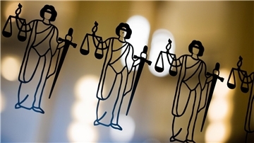Die Justitia ist an einer Scheibe am Eingang zum Oberlandesgericht zu sehen.