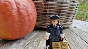 Luther-Playmobilfigur vor einem Kürbis
