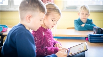Zwei Kinder an einem Tablet