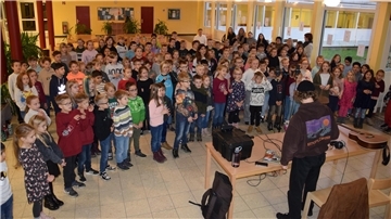 Kinden singen Weihnachtslieder in der Aula der Grundschule in Abbehausen. 
