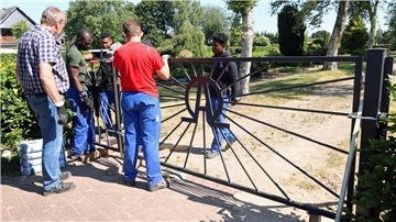 Montage des neuen Metalltors am Uthleder Friedhof