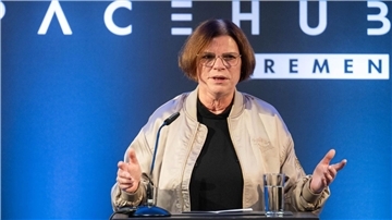 Frau am Rednerpult. 