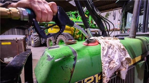 Ein Landwirt in der Region Hannover betankt einen Radlader in seiner Fahrzeughalle mit Diesel.