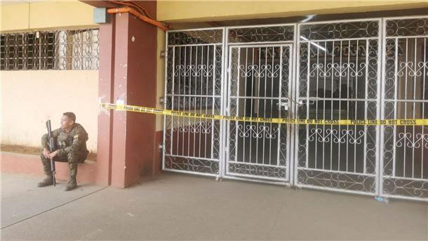 Philippinen: Tote bei Explosion während katholischer Messe Ein philippinischer Polizist bewacht den Eingang des Ortes, an dem eine Bombe explodiert ist.