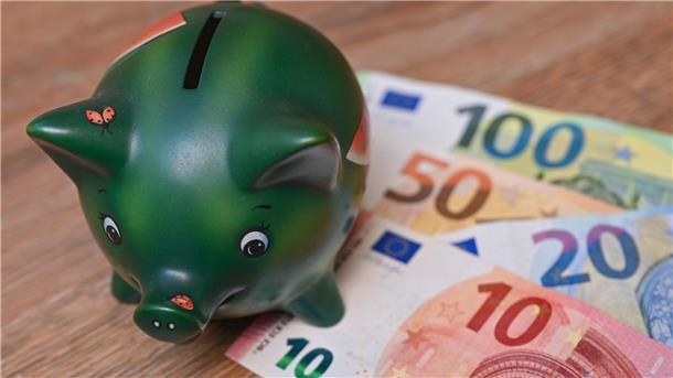 Inflation in Niedersachsen schwächt sich auf 3,1 Prozent ab Ein Sparschwein steht auf einem Tisch neben Eurobanknoten.
