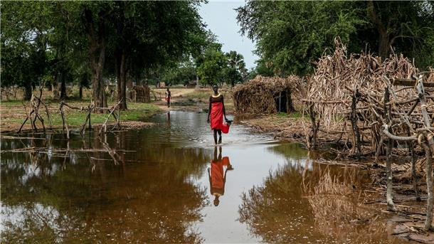 Eine Frau watet durch das Hochwasser zwischen verlassenen Unterkünften im Dorf Majak Awar im Südsudan. Dort sind ganze Bundesstaaten überflutet. Sieben der zehn Klimakrisenherde, die die Nichtregierungsorganisation Oxfam in einer aktuellen Studie identifiziert hat, liegen in Afrika.