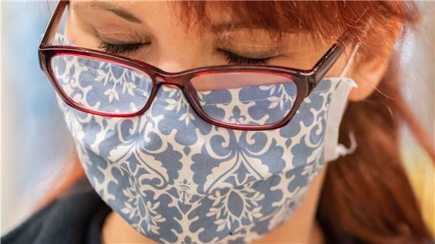 Eine Mitarbeiterin in einem Supermarkt trägt eine Schutzmaske. Um die Ausbreitung des Coronavirus zu verlangsamen, hat die Bundesregierung das Tragen der Mund-Nase-Bedeckung angeordnet.