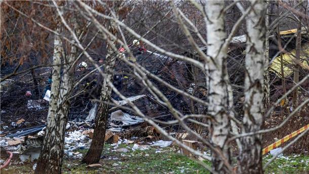 Ermittler bergen Flugschreiber nach Absturz in Litauen Einsatzkräfte an den Trümmern der abgestürzten Maschine.