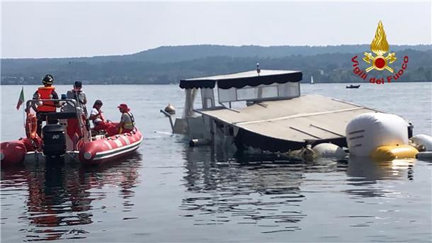 Einsatzkräfte der Feuerwehr holen das gesunkene Boot auf dem Lago Maggiore mit Ballons an die Oberfläche.