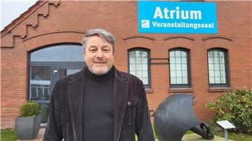 Ein Mann mit grauen Haaren und einem Jackett steht lächelnd vor einem Haus. Er ist der neue Veranstaltungsleiter von Tourismus-Service Butjadingen (TSB). 