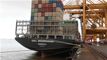 Heck eines Containerschiffs an der Kaje