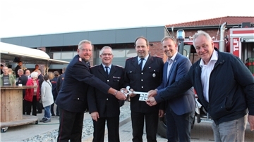 Gemeindebrandmeister Marco Bräuer (Zweiter von links) und sein Stellvertreter Manfred Siedenburg (Mitte) nehmen offiziell den Schlüssel von Bürgermeister Guido Dieckmann (Zweiter von rechts, sowie dem Architekten Lutz Padberg (rechts) mit Gemeindebrandmeister Ralf Meyer (links) entgegen.