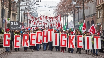 „Gerechtigkeit“ - Teilnehmer ziehen beim „Stadtstaatenstreik“ durch die Hamburger Mönckebergstraße.