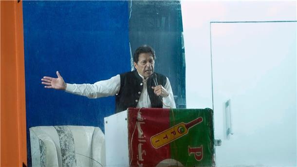 Geschützt durch eine kugelsichere Barriere spricht Imran Khan, ehemaliger Premierminister von Pakistan, während einer Kundgebung.  Khan ist wegen Ermittlungen in einem Korruptionsverfahren in Islamabad verhaftet worden.