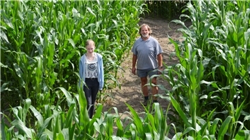 Hans-Heinrich Heins mit Nachbarstochter und Helferin Jeanette Eichhorn auf einem der Wege durchs Maislabyrinth. Am 25. Juli um 13 Uhr eröffnet Heins die Saison, die bis zum 4. Oktober andauern soll.