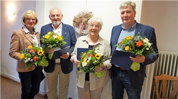 Henriette Ahrens, Klaus Böse, Beate Börsmann und Lutz Frese mit Blumensträußen sowie Ehrenurkunde und Ehrennadel der Gemeinde Beverstedt 