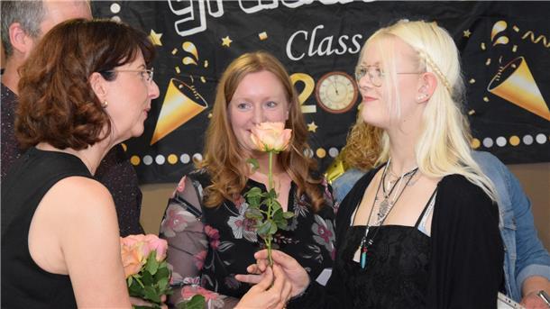 Jeder Abschlussschüler und jede Abschlussschülerin erhält eine Rose mit dem Zeugnis.