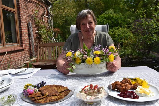 Das Foto zeigt Ursula Schröder mit Löwenzahngerichten. 