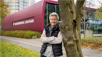 Ingrid Haderer vor dem begehbaren Riesenbuch - der Stadtteilbibliothek in Bremerhaven-Leherheide. 