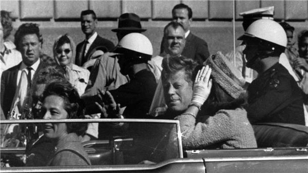 Kurz vor seiner Ermordung sitzt der damalige US-Präsident John F. Kennedy am 22.11.1963 in Dallas zusammen mit seiner Frau Jacqueline Kennedy (r) sowie dem dem Gouverneur von Texas, John Connally, und desen Frau Nellie Connally in einer offenen Limousine.
