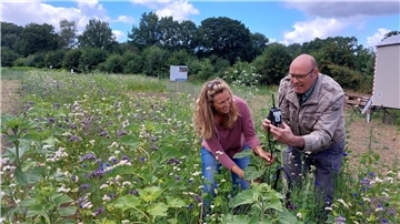 Landwirtin Linda Hühnken und Professor Jelle Bijma kontrollieren die Messgeräte, die auf den Versuchsflächen verteilt sind.
