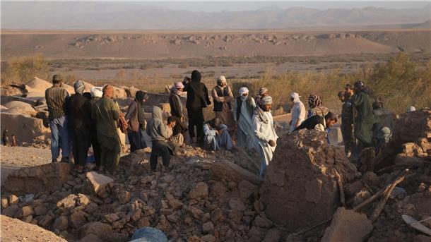Fast 2500 Tote: Verzweiflung nach Erdbeben in Afghanistan Menschen stehen nach dem Erdbeben in der afghanischen Provinz Herat in den Trümmern ihrer Wohnhäuser.